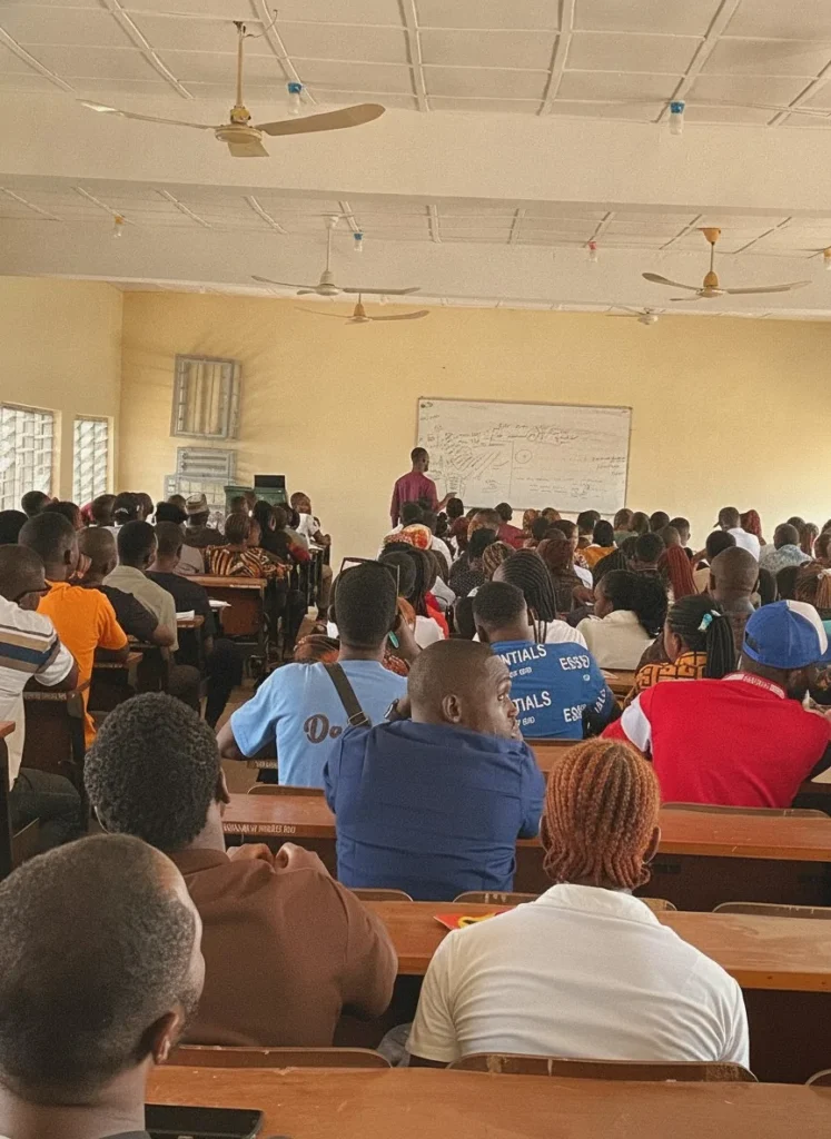 Rows of students listening in a hall