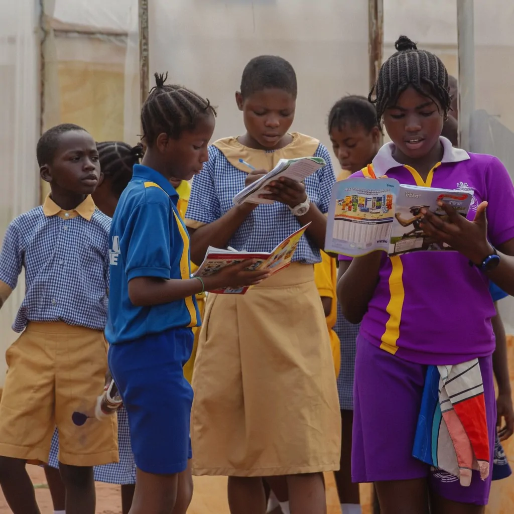 Pupils in school uniform reading garden guides together